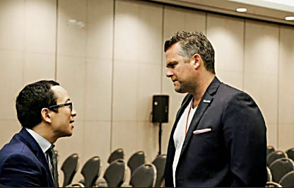 William Skelley in conversation at a conference